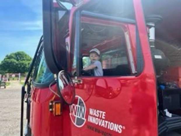 Child in WIN truck at Touch-A-Truck event with the Foxboro REC Department in Foxboro, MA
